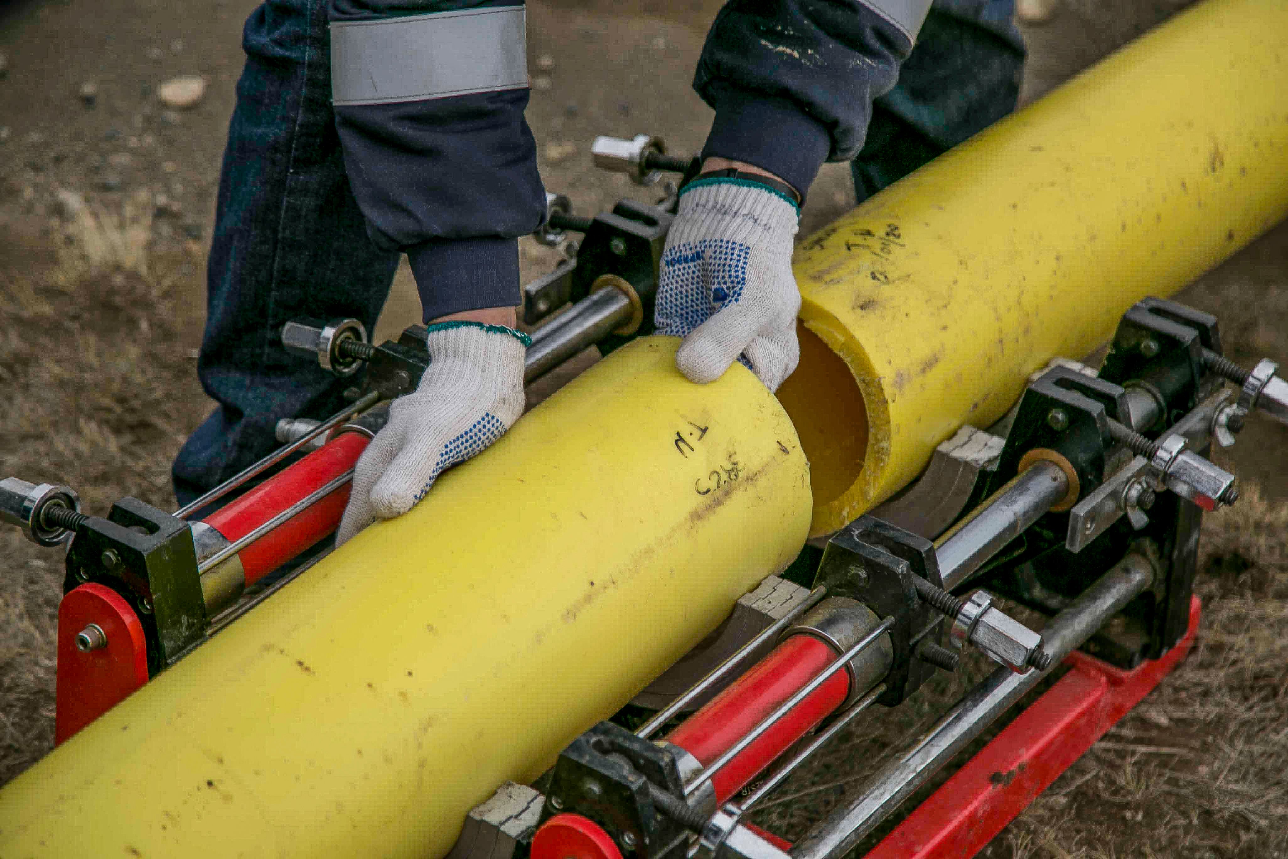 Crew joining sections of large-diameter pipe on site