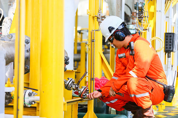 Field technician inspecting pipeline valve equipment