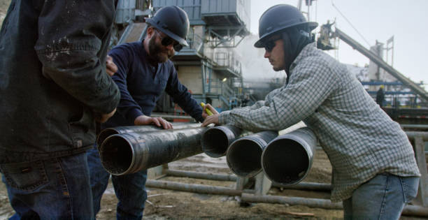 Crew joining pipe sections at a fabrication yard